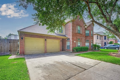 Wide driveway with attached garage offers ample pa