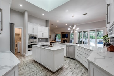 Kitchen featuring decorative backsplash, applianc