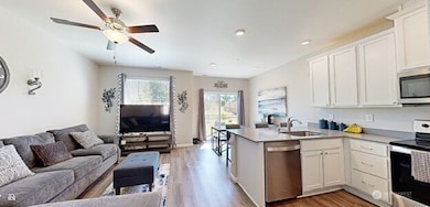 View from hallway of living room and kitchen