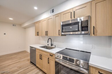 Kitchen with stainless steel appliances, light bro