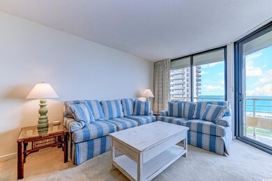 Carpeted living room featuring a water view