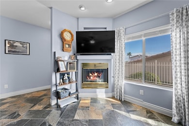 Living area with stone tile floors, a glass covere