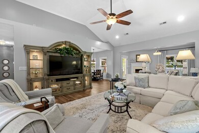 Living room with lofted ceiling, hardwood / wood-s