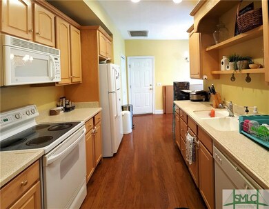 Pine cabinets and corian counters highlight this g