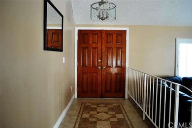 Front double-door entry with custom tile flooring