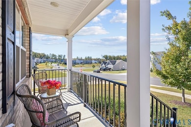 Covered porch featuring a residential view