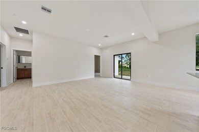 Unfurnished room featuring light wood-style floors, recessed lighting, and beamed ceiling