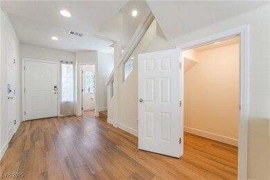 Entrance foyer with light wood finished floors, ba