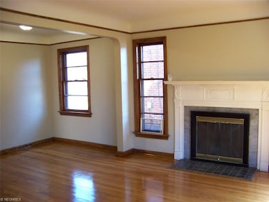 The living room has a wood burning fireplace