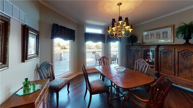 Large formal dinning area with hardwood flooring a