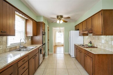 Updated Kitchen features Tile Floor, Granite, Tumb