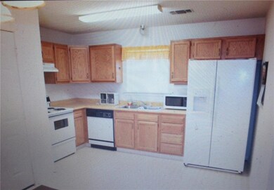 Spacious kitchen, seller leaving fridge, door open