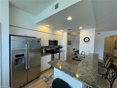 Kitchen with light wood-type flooring, white cabin