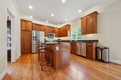 Ample sized kitchen with island, dining area and opens into the family room