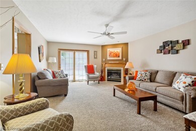 Spacious great room with gas fireplace, newer carpet and sliding doors leading to a large deck.