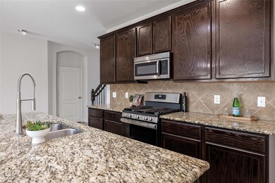 Kitchen featuring appliances with stainless steel