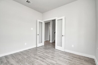 Another view of the home office, with French doors