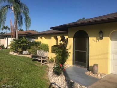Screened front entry, curbed landscaping and inground sprinkler system.