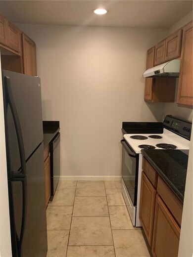 Kitchen with dishwasher, range hood, refrigerator,