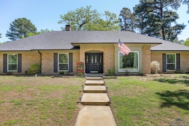 Single story home with a chimney, a shingled roof,