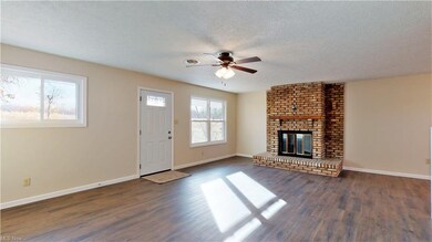 Large living room with brick fireplace.
