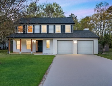 View of front facade featuring concrete driveway, 