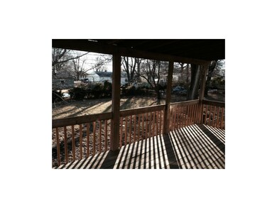 great treed backyard with covered deck