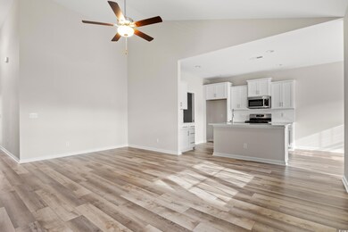 Unfurnished living room with ceiling fan, sink, hi