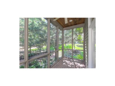 Quaint and private screened in porch with brick fl