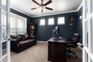 Office area featuring light carpet, french doors,