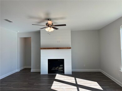 Unfurnished living room with dark hardwood / wood-