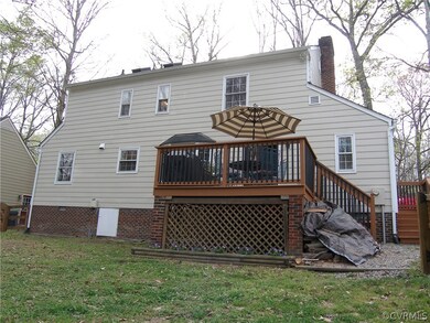 Rear Deck with Lattice Underneath surrounded by a planting bed of pansies, Exterior of the House Painted 2017