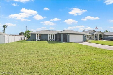 Single story home featuring a front yard and a garage
