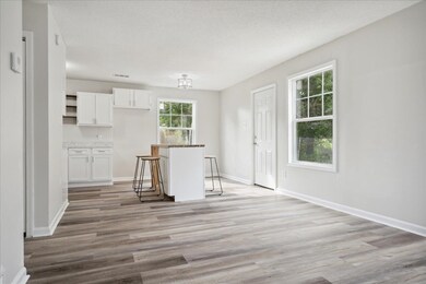 Kitchen featuring a breakfast bar area, a textured