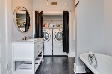 Washer and dryer in curtained laundry nook.