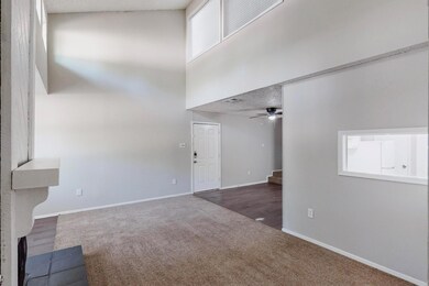 Unfurnished living room featuring baseboards, a hi