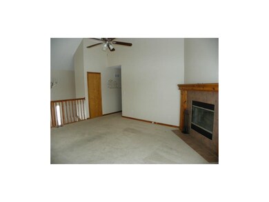 Living room has fireplace and ceiling fan.