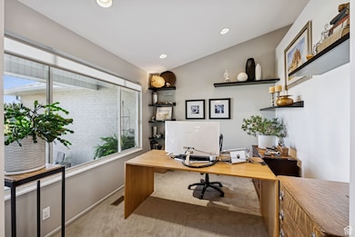 Home office with light carpet, recessed lighting, and lofted ceiling