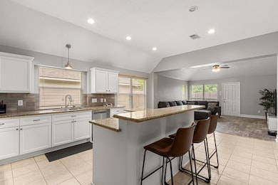 Features include modern white cabinetry, granite c