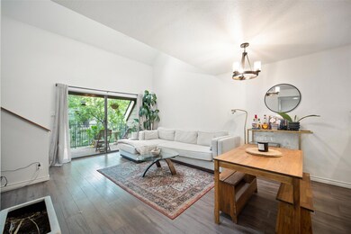 Living area with a chandelier and dark wood-style