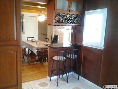 Large pantry area with eating barstool, wine rack