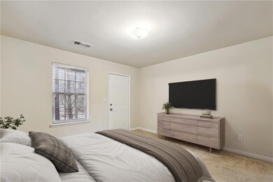 Bedroom featuring light colored carpet and baseboards