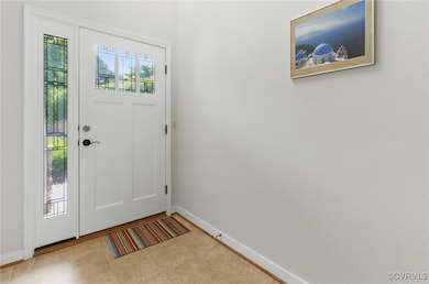 Entrance foyer featuring baseboards and tile patte
