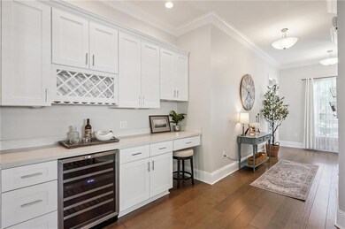 BAR AREA WITH WINE/BEVERAGE FRIDGE, WINE & GLASS STORAGE, DESK AREA, & PLENTY OF CABINETS