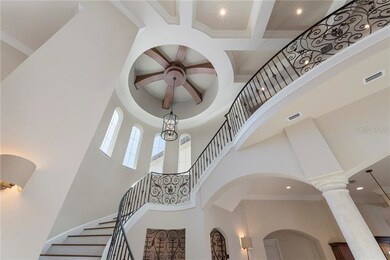 Soaring ceiling and dramatic curved iron staircase