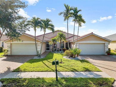 View of front of house with a garage and a front y