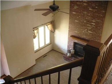 LOOKING DOWN FROM LOFT INTO THE LIVING ROOM, WITH 