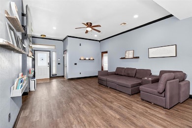 Living room with ceiling fan, wood finished floors, crown molding, and recessed lighting