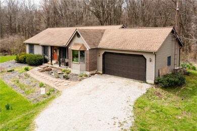 Ranch-style home featuring a porch, a shingled roof, driveway, and a garage