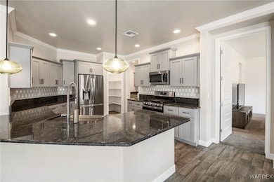 Kitchen with a peninsula, stainless steel applianc